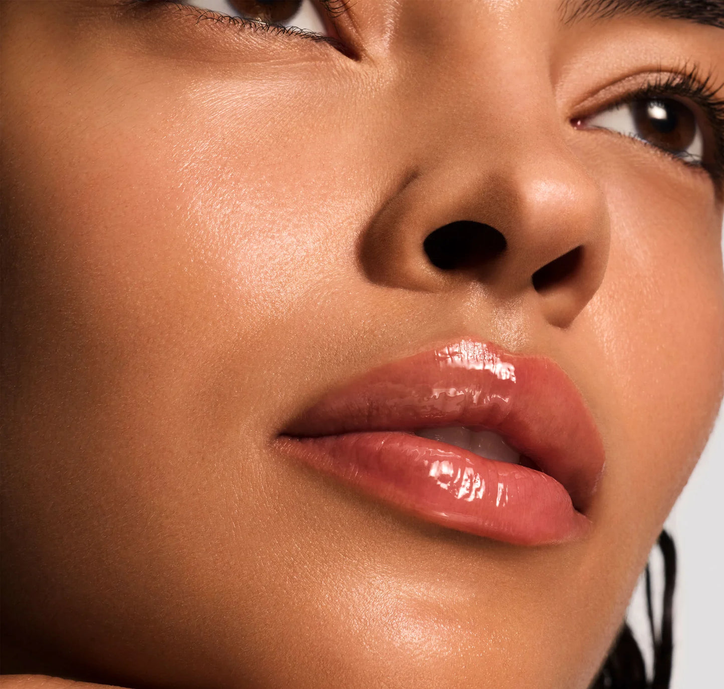 Close-up of a woman's lips with a neutral background