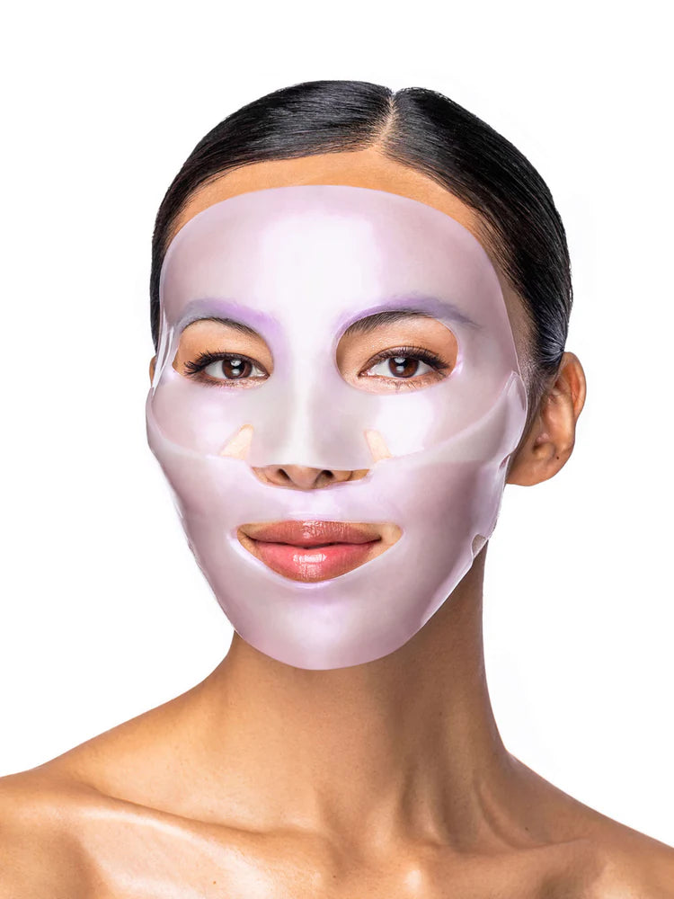 Woman wearing a light purple face mask against a white background