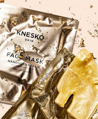 Knesko skin face mask packaging with gold foil on a beige background